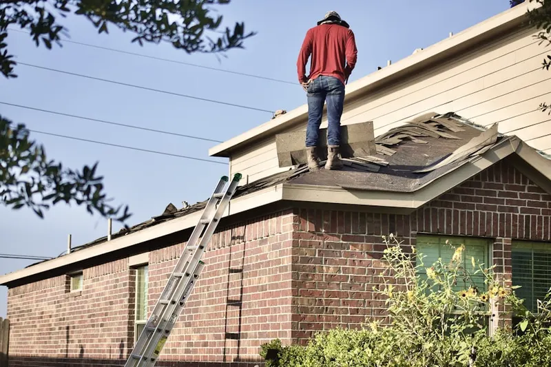 Professional roofer working on a residential roof in Stuyvesant-Prospect
